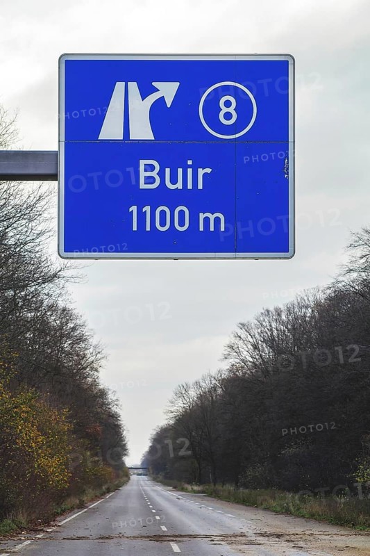 A traffic sign with a directional arrow points to the Buir motorway exit under a blue sky, abandoned A4 motorway, Lost Place, Buir, Kerpen, North Rhine-Westphalia, Germany, Europe