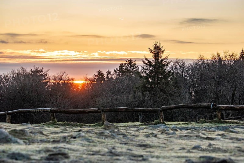 Landscape on the Grosser Feldberg, Taunus volcanic region. A cloudy, sunny winter day, meadows, hills, snow and forests with a view of the winter sunset. Hesse, Germany, Europe