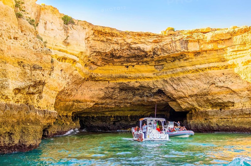 Albufeira, Portugal, May 28, 2022: Tourists in the boats sightseeing the caves on Algarve coast, Europe