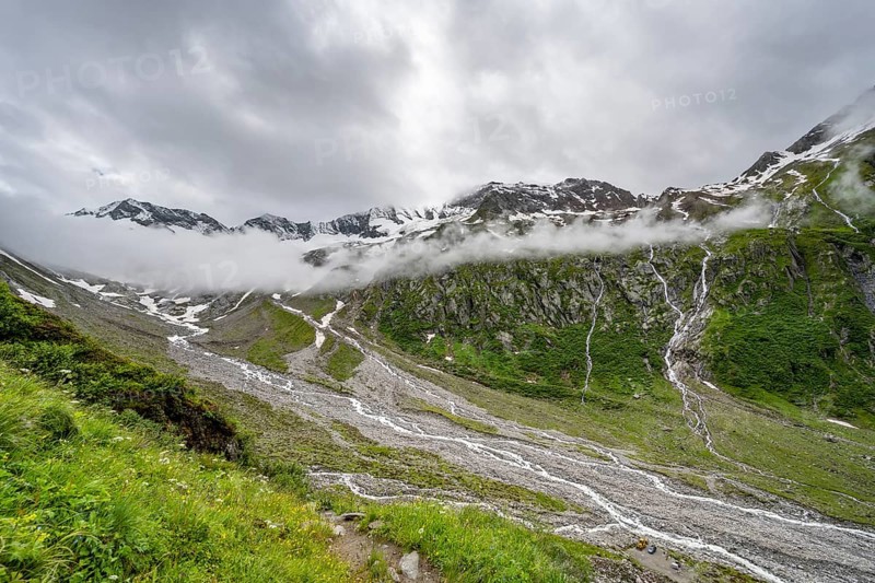 Cloudy valley of the Schlegeisgrund with mountain stream, glaciated mountain peaks Hoher Weiszint and glacier Schlegeiskees, Berliner Hoehenweg, Zillertal, Tyrol, Austria, Europe