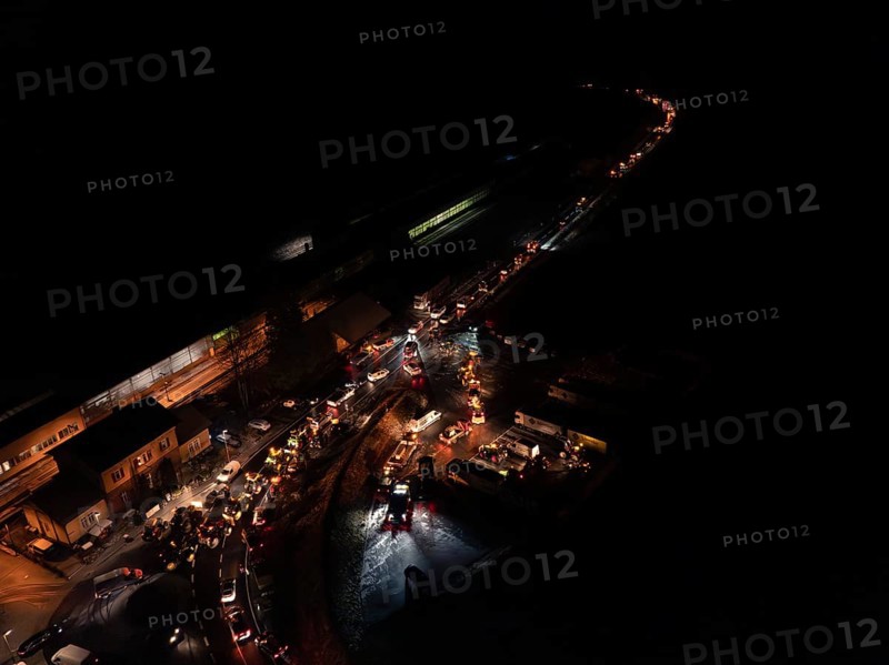 Night view of an illuminated road full of tractors and people, farmers protest, Black Forest, Bad Teinach, Germany, Europe
