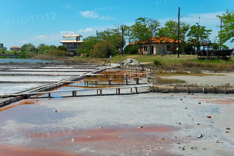 Salt extraction plant with natural landscape in the background and a clear blue sky, therapeutic mud and salt extraction, Salt Museum, Pomorie, Burgas, Bulgaria, Europe