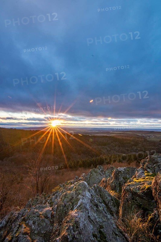 Landscape at the Grosser Zacken, Taunus volcanic region. A cloudy, sunny autumn day, meadows, hills, fields and forests with a view of the sunset. Hesse, Germany, Europe
