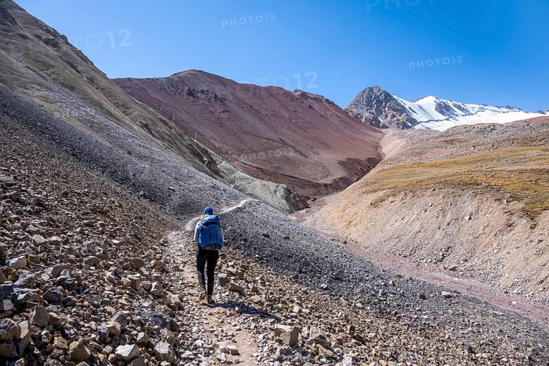 Barren high mountains, hiker on the hiking trail to the base camp of Lenin Peak, Osh Province, Kyrgyzstan, Asia