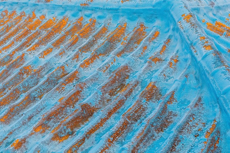 Paint peeling and rust visible on top of old blue metal roof