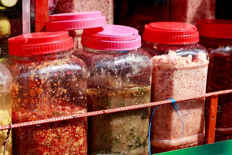 Rows of assorted authentic traditional khmer crack sauces called Chrouk Metae or chili paste, prahok or fermented fish paste and Tuk trey or fish paste sold in the local market of Kampot, Cambodia, Asia