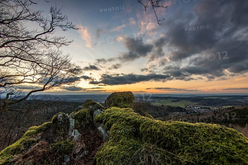 Landscape at the Grosser Zacken, Taunus volcanic region. A cloudy, sunny autumn day, meadows, hills, fields and forests with a view of the sunset. Hesse, Germany, Europe