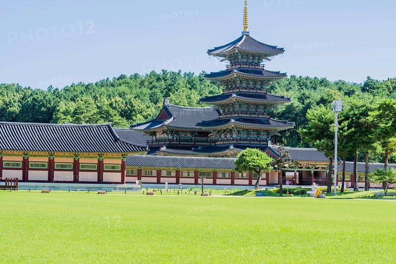 Buyeo, South Korea, July 7, 2018: Main gate of Neungsa Baekje Temple with golden spire on top of five story pagoda, Asia