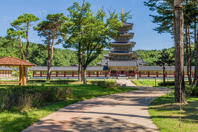 Buyeo, South Korea, July 7, 2018: Sidewalk leading to main gate of Neungsa Baekje Temple with five story pagoda, Asia