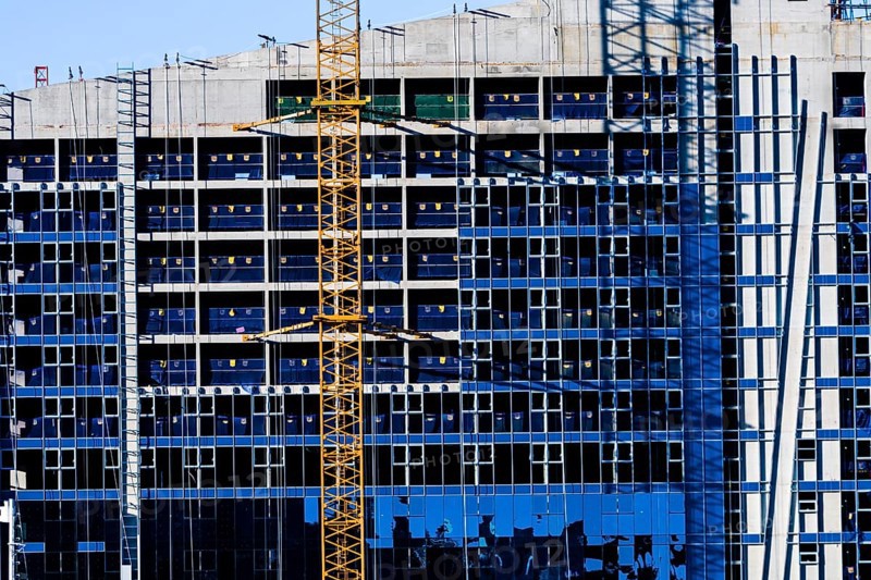 Yeoso, South Korea: December 25, 2017: Yellow crane attached to side of building that is under construction