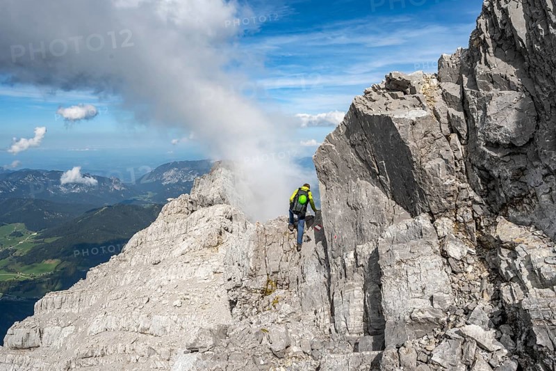 Mountaineer on a narrow rocky ridge, Watzmann crossing to Watzmann Mittelspitze, view of mountain panorama, Berchtesgaden National Park, Berchtesgaden Alps, Bavaria, Germany, Europe