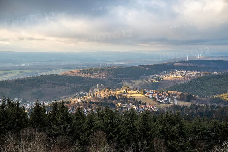 Landscape on the Grosser Feldberg, Taunus volcanic region. A cloudy, sunny winter day, meadows, hills, snow and forests with a view of the winter sunset. Hesse, Germany, Europe