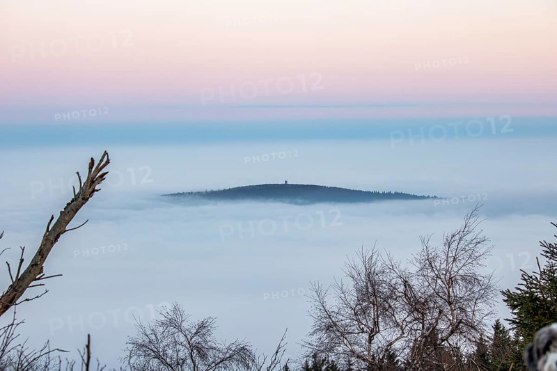 Landscape on the Grosser Feldberg, Taunus volcanic region. A cloudy, sunny winter day, meadows, hills, snow and forests with a view of the winter sunset. Hesse, Germany, Europe