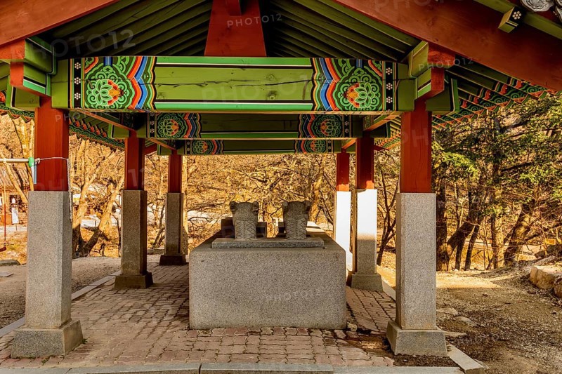 Rear view of covered water cistern with dragon head fountains at Buddhist temple
