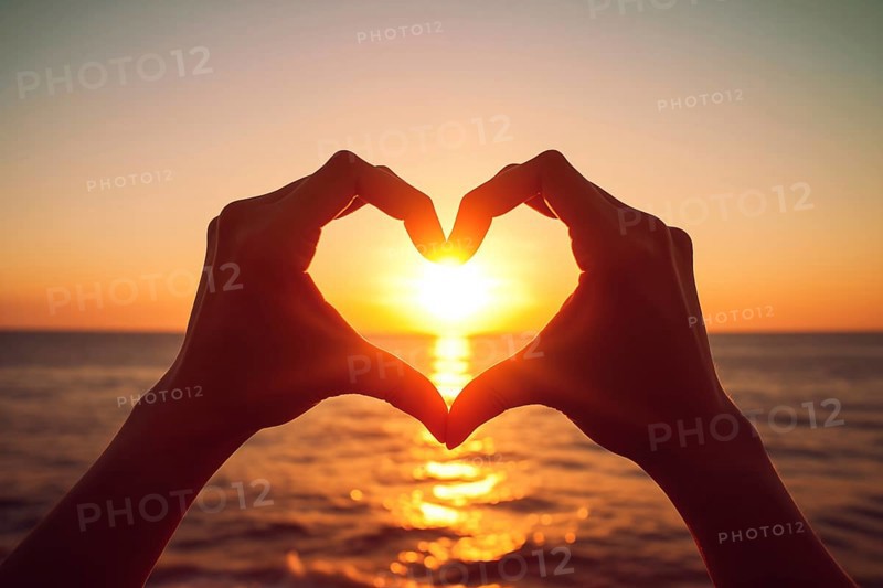 Two hands forming a heart shape, silhouetted against a breathtaking ocean sunset. Love and warmth on Valentine Day or any romantic occasion, AI generated