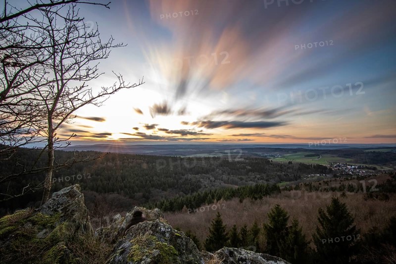 Landscape at the Grosser Zacken, Taunus volcanic region. A cloudy, sunny autumn day, meadows, hills, fields and forests with a view of the sunset. Hesse, Germany, Europe