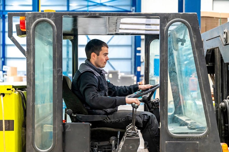 Man driving a forklift in a modern cnc logistic factory