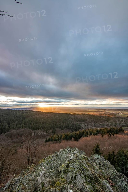 Landscape at the Grosser Zacken, Taunus volcanic region. A cloudy, sunny autumn day, meadows, hills, fields and forests with a view of the sunset. Hesse, Germany, Europe