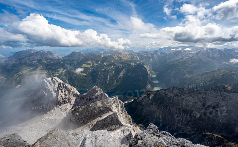 View from the rocky summit of the Watzmann Mittelspitze, view of mountain panorama with Steinernes Meer and Koenigssee, Kleiner Watzmann and Watzmann Kinder, Watzmann crossing, Berchtesgaden National Park, Berchtesgaden Alps, Bavaria, Germany, Europe