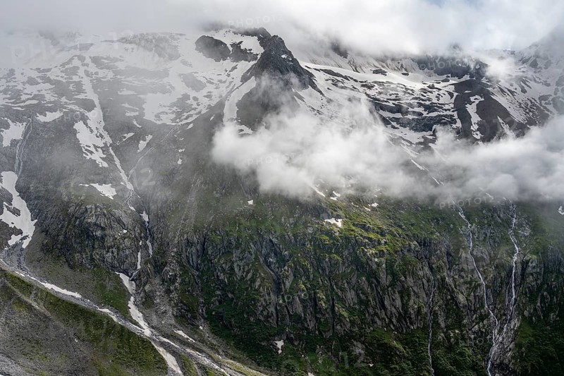 Snow-covered cloudy mountains with Pfitscher ridge and glacier Roetkees, mountain streams as waterfalls on a mountain slope, Furtschaglhaus, Berliner Hoehenweg, Zillertal, Tyrol, Austria, Europe