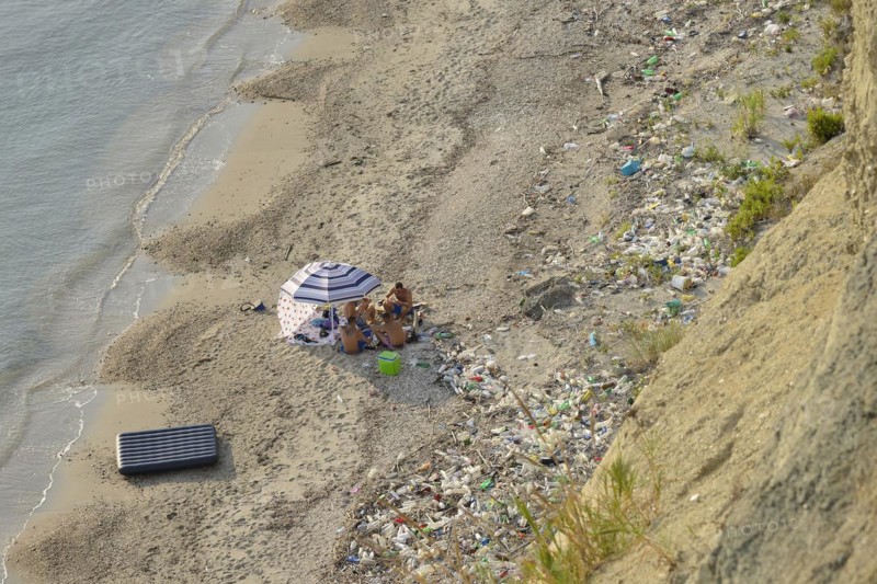 Picnic on the beach among washed up rubbish, Cape Rodon, Albania, Europe