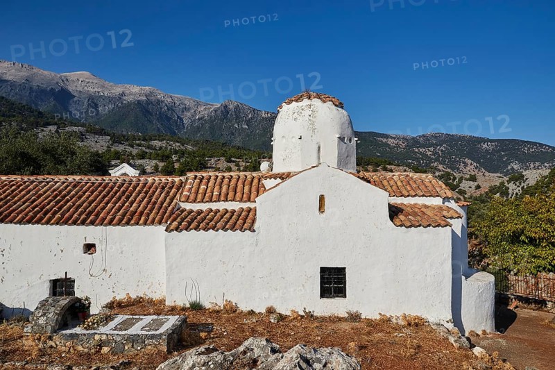 Church of St Michael the Archangel, Cross-domed church, White church architecture against a background of mountains and blue sky, Aradena Gorge, Aradena, Sfakia, Crete, Greece, Europe