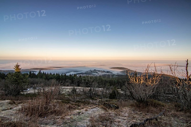 Landscape on the Grosser Feldberg, Taunus volcanic region. A cloudy, sunny winter day, meadows, hills, snow and forests with a view of the winter sunset. Hesse, Germany, Europe