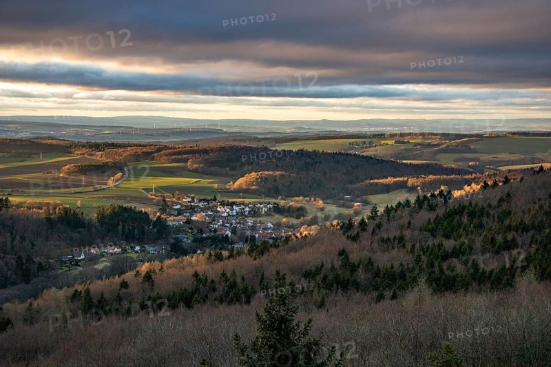 Landscape at the Grosser Zacken, Taunus volcanic region. A cloudy, sunny autumn day, meadows, hills, fields and forests with a view of the sunset. Hesse, Germany, Europe