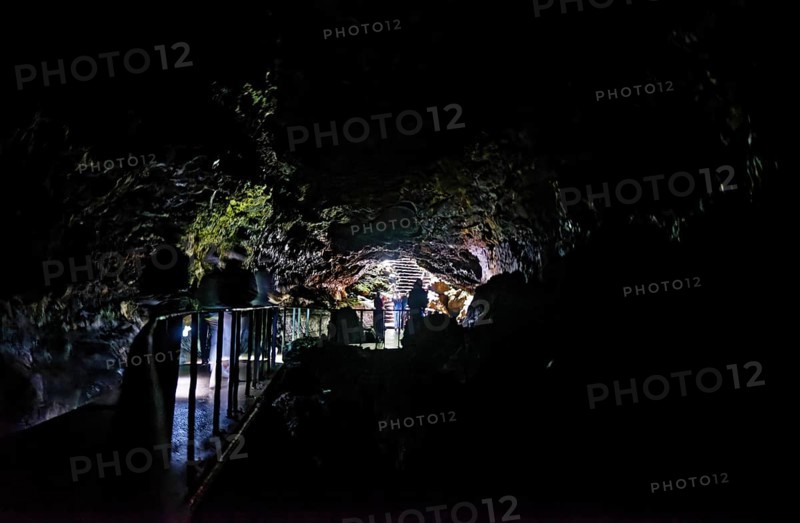 People walking to the cave exit in the lava tunnel Gruta das Torres, Gruta das Torres, Pico, Sao Miguel, Faial, Azores, Portugal, Europe