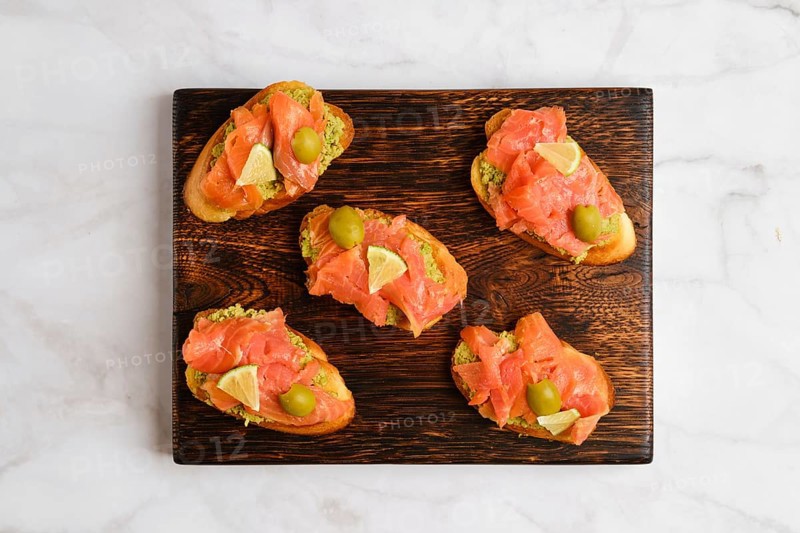 Top view of sandwiches with salted salmon and avocado