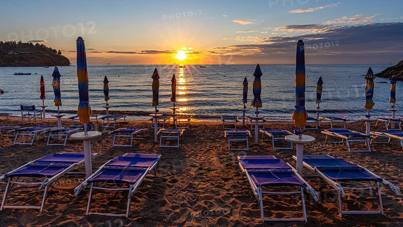 Sun loungers and parasols on Straccolignino beach at sunrise, near Capoliveri, Elba, Tuscan Archipelago, Tuscany, Italy, Europe