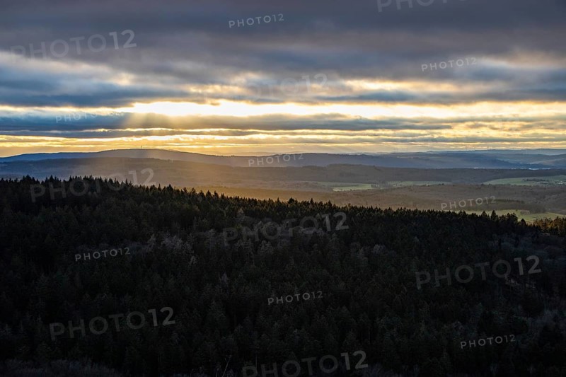 Landscape at the Grosser Zacken, Taunus volcanic region. A cloudy, sunny autumn day, meadows, hills, fields and forests with a view of the sunset. Hesse, Germany, Europe