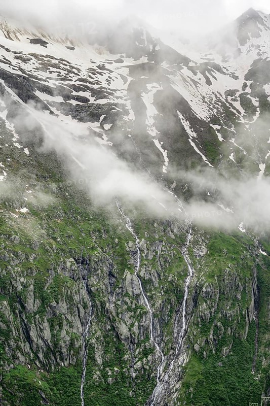 Snow-covered cloudy mountains, mountain streams as waterfalls on a mountain slope, Furtschaglhaus, Berliner Hoehenweg, Zillertal, Tyrol, Austria, Europe