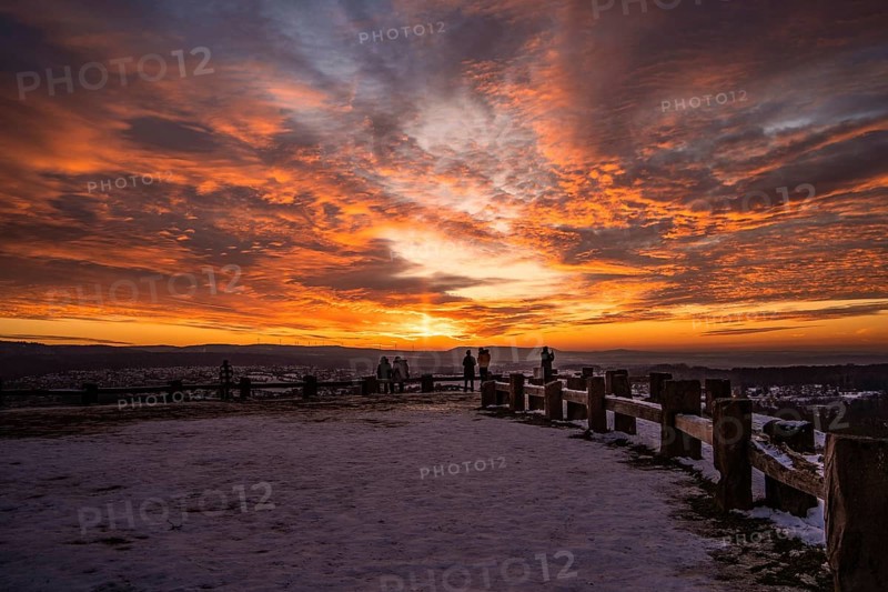People watching an impressive sunset in the snowy terrain, Wallberg, Pforzheim, Germany, Europe