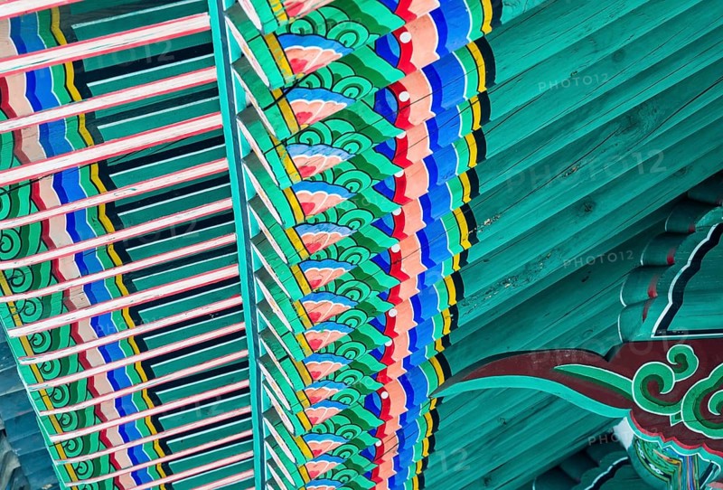 Underside of the roof of a pagoda with vivid colors painted in oriental design