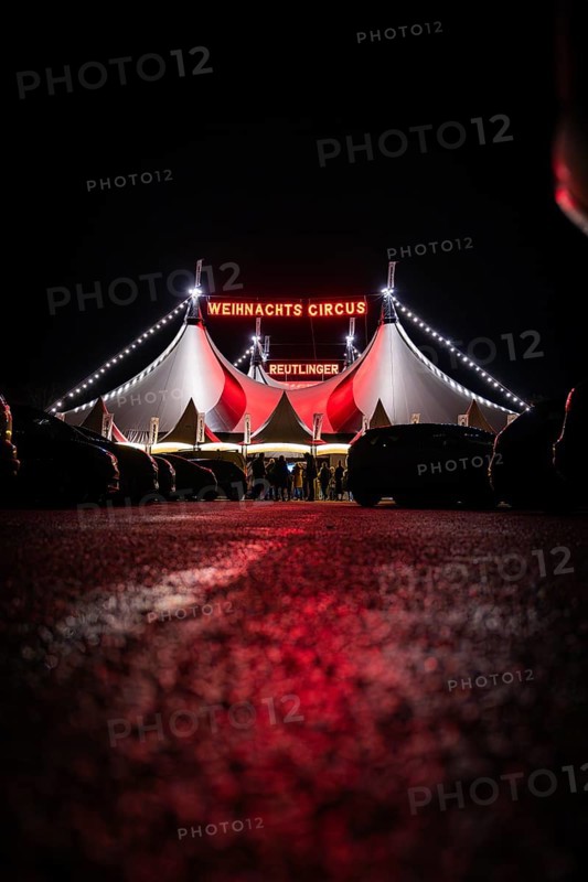 People in front of the illuminated 'Christmas Circus' tent at night, Reutlingen, Germany, Europe