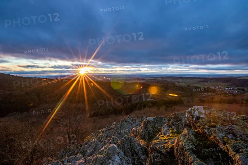 Landscape at the Grosser Zacken, Taunus volcanic region. A cloudy, sunny autumn day, meadows, hills, fields and forests with a view of the sunset. Hesse, Germany, Europe