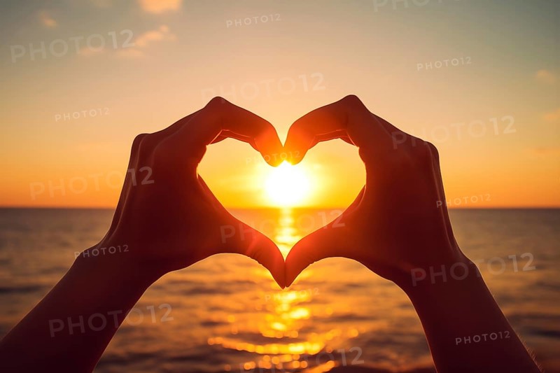 Two hands forming a heart shape, silhouetted against a breathtaking ocean sunset. Love and warmth on Valentine's Day or any romantic occasion, AI generated