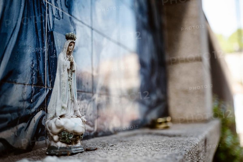 Holy Mary statue with the religious background made of Portuguese traditional tiles, Porto, Portugal, Europe