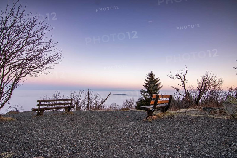Landscape on the Grosser Feldberg, Taunus volcanic region. A cloudy, sunny winter day, meadows, hills, snow and forests with a view of the winter sunset. Hesse, Germany, Europe