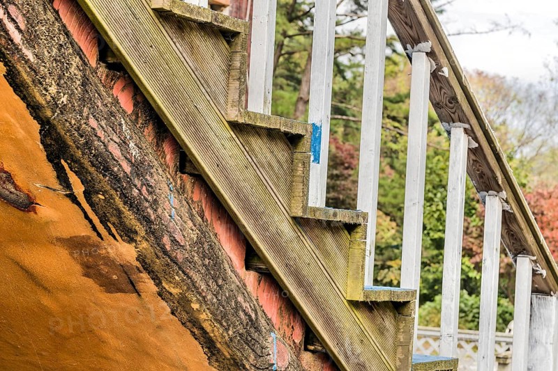 Closeup of wooden outdoor staircase on old abandoned building