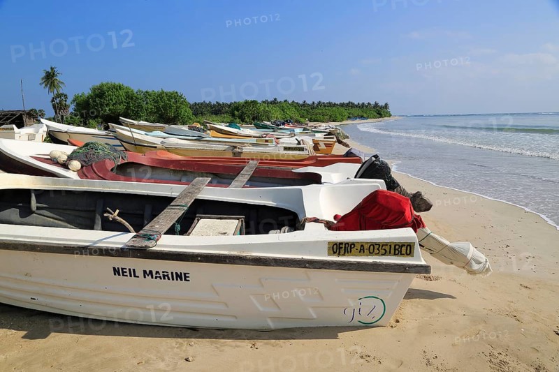 Boats and fishing canoes tropical beach at Pasikudah Bay, Eastern Province, Sri Lanka, Asia