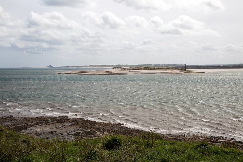Narrow coastal channel between mainland and Holy Island, Lindisfarne, Northumberland, England, UK