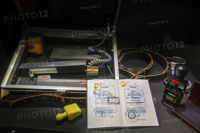 Passport with visas for West-Berlin and FRG and ID check kit including UV control apparatus used by East German STASI officers at the Memorial de Caen, museum and war memorial in Caen, Normandy, France, Europe
