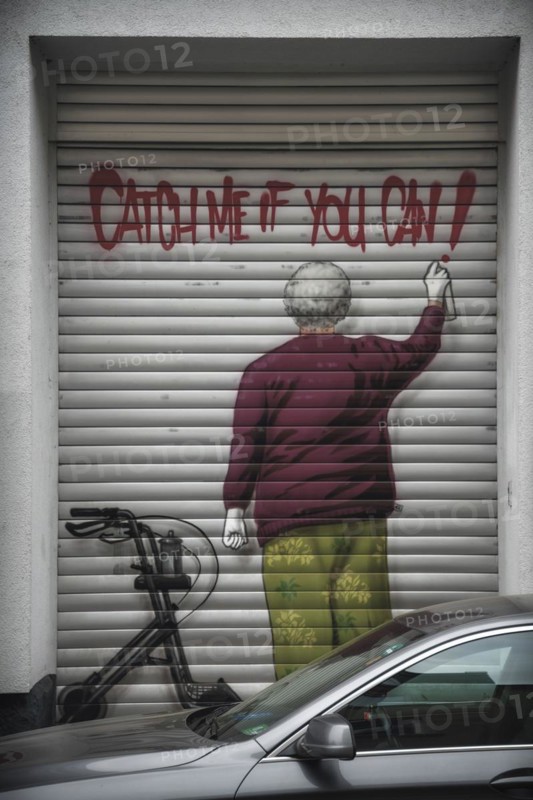 Garage door with graffiti of a man spraying 'Catch me if you can', Wuppertal Elberfeld, North Rhine-Westphalia, Germany, Europe