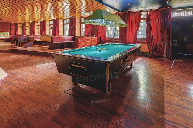 Cosy billiard room with a large table and red curtains, Bad am Park, Lost Place, Essen, North Rhine-Westphalia, Germany, Europe