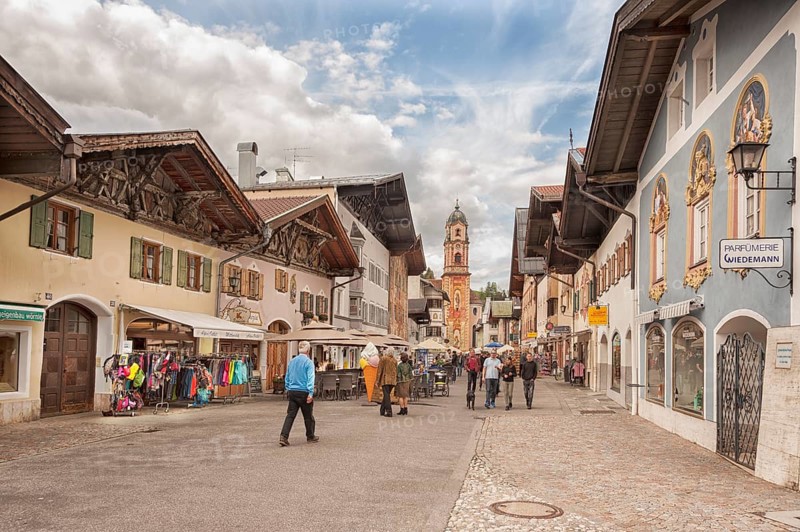 Obermarkt, shops, pedestrian zone, St Peter and Paul church at the back, Mittenwald, Bavaria