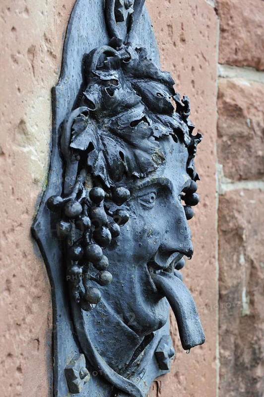 Fountain with Bacchus figure in the vineyards at Dambach-la-Ville, Vosges, Alsace, France, Europe