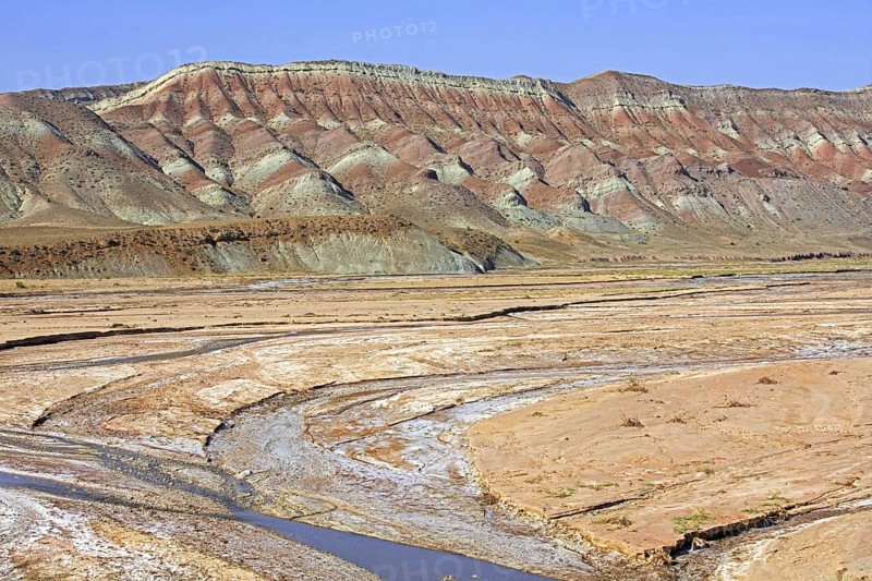 Semi-arid Azerbaijan shrub desert landscape showing mountain with sediment layers and riverbed, East Azerbaijan Province, Iran, Asia