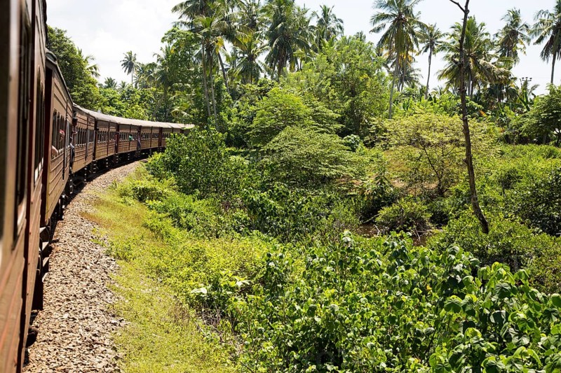 Railway train passing through countryside between Galle and Mirissa, Sri Lanka, Asia